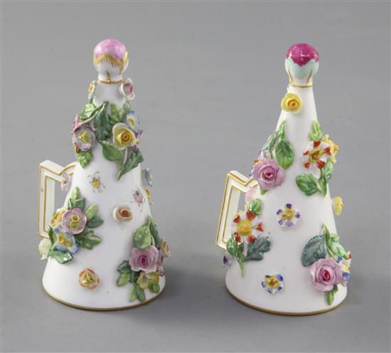 A pair of Meissen floral encrusted candle extinguishers, 19th century,